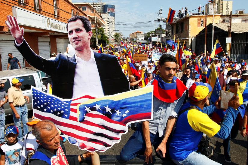  Opposition supporters carrying a cardboard cut-out of Venezuelan opposition leader Juan Guaido take part in a rally against Venezuelan President Nicolas Maduro's government and to commemorate the Day of the Youth in Maracaibo, Venezuela February 12, 2019. REUTERS