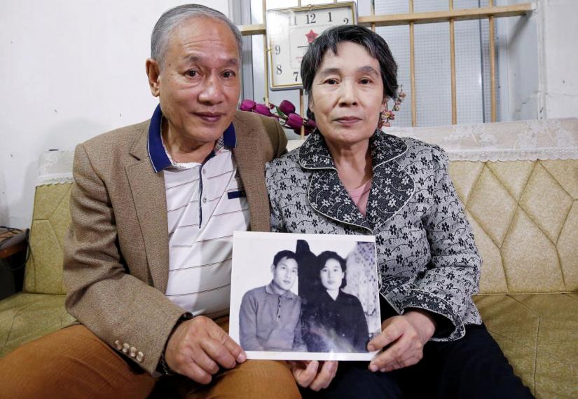 Former Vietnamese chemical student Pham Ngoc Canh who studied in North Korea and his North Korean wife Ri Yong Hui hold their first photo together which was taken in Spring 1971, at their house in Hanoi, Vietnam February 12, 2019. Picture taken February 12, 2019. REUTERS