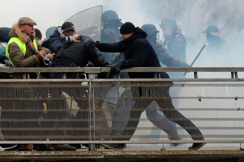 Former French boxing champion, Christophe Dettinger is seen during clashes with French Gendarmes as part of a demonstration by the `yellow vests` on the passerelle Leopold-Sedar-Senghor bridge in Paris, France, January 5, 2019. REUTERS/File Photo