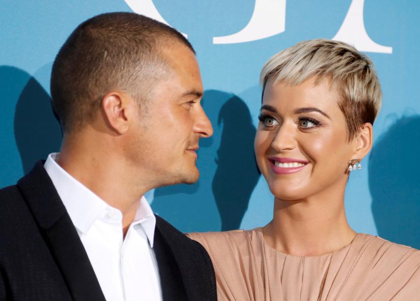 Singer Katy Perry and actor Orlando Bloom smile upon their arrival for the Monte-Carlo Gala for the Global Ocean in Monaco, September 26, 2018. REUTERS/Eric Gaillard/File Photo