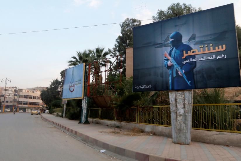 Islamic State billboards are seen along a street in Raqqa, eastern Syria, which is controlled by the Islamic State, October 29, 2014. The billboard (R) reads: `We will win despite the global coalition`. REUTERS/File Photo