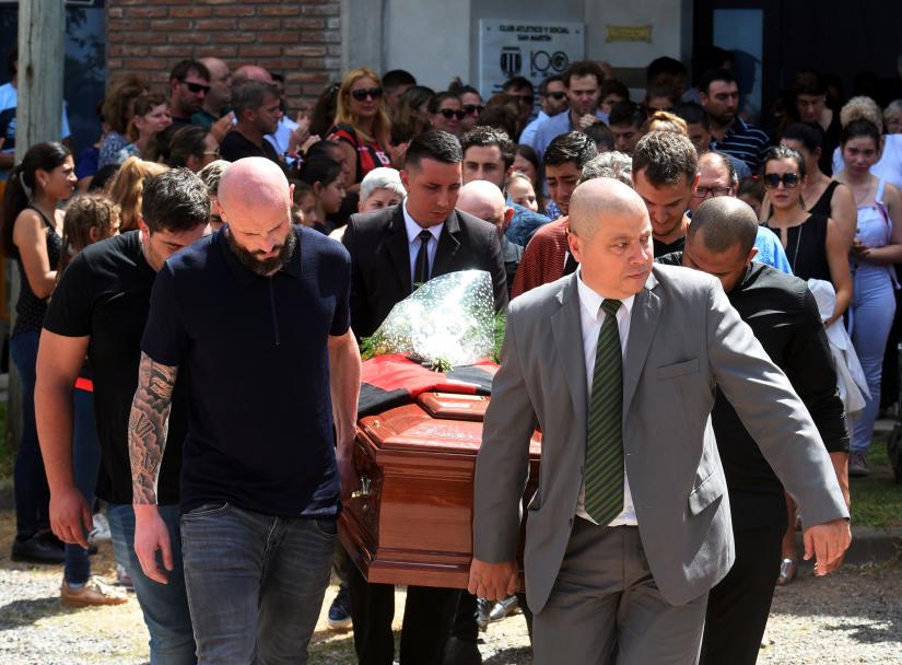 Family and friends carry the coffin of Emiliano Sala, soccer player who died in a plane crash in the English Channel, while a crowd attends his wake at Club Atletico y Social San Martin in Progreso, Argentina February 16, 2019. REUTERS