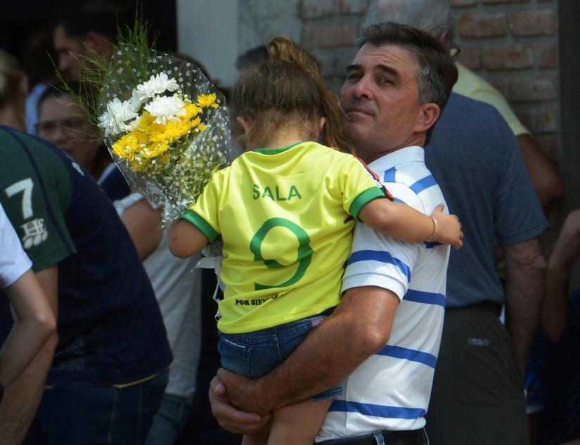 A girl wearing Emiliano Sala`s jersey, former striker of French club Nantes, who died in a plane crash in the English Channel, attends his wake in Progreso, Argentina February 16, 2019. REUTERS