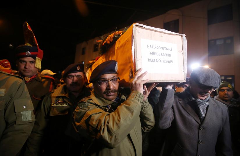 Indian police officers carry the coffin containing the body of their fallen colleague, who according to police was killed in a gun battle between suspected militants and security forces in south Kashmir’s Pulwama district, during his wreath-laying ceremony in Srinagar, February 18, 2019. REUTERS