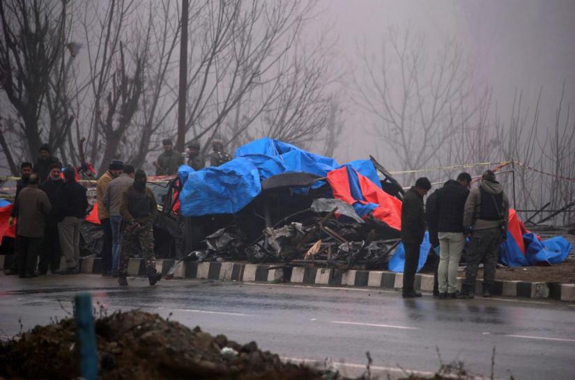 Forensic officials inspect the wreckage of a bus after a suicide bomber rammed a car into the bus carrying Central Reserve Police Force (CRPF) personnel on Thursday, in Lethpora in south Kashmir`s Pulwama district, February 15, 2019. REUTERS