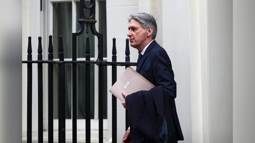 Britain`s Chancellor of the Exchequer Philip Hammond is seen outside Downing Street in London, Britain, February 13, 2019. REUTERS
