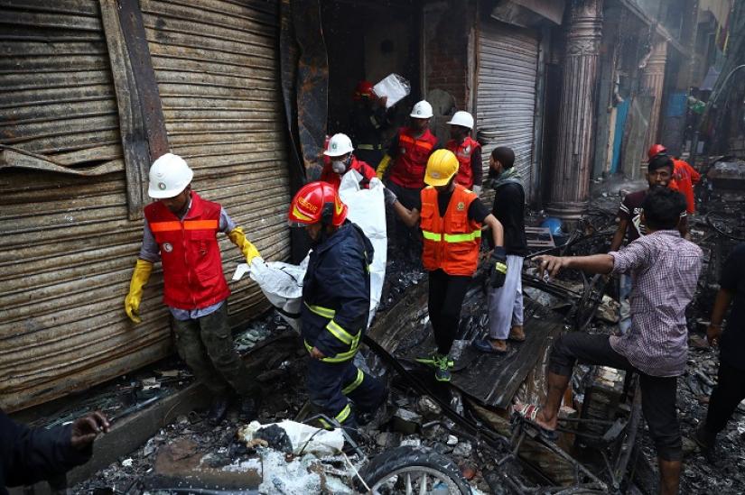 Volunteers recover a dead body from a burnt warehouse in Dhaka, Bangladesh, February 21, 2019. REUTERS