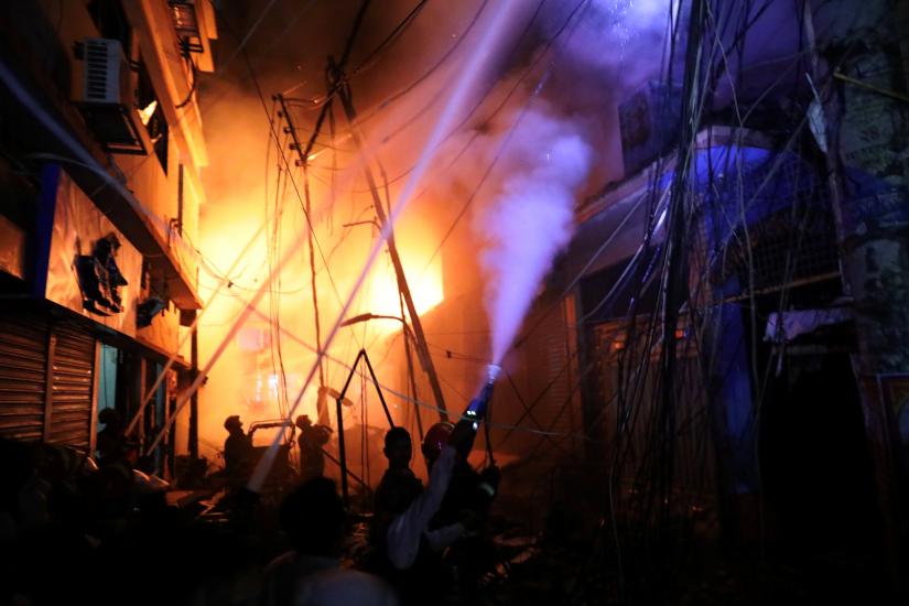 Firefighters work at the scene of a fire that broke out at Chawkbazar in Dhaka, Bangladesh February 21, 2019. REUTERS