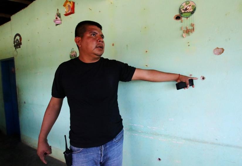 A community member shows bullets marks in a house after Venezuelan soldiers opened fire on indigenous people near the border with Brazil on Friday, killing two, in Kumarakapay, Venezuela, Feb 22, 2019. REUTERS