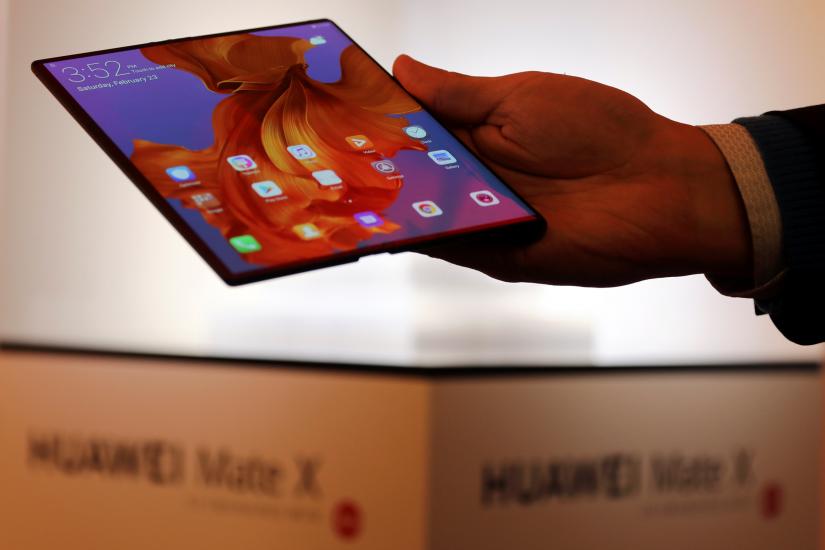 A member of Huawei staff shows the new Huawei Mate X device during a pre-briefing display ahead of the Mobile World Congress in Barcelona, Spain, February 23, 2019. Picture taken February 23, 2019. REUTERS