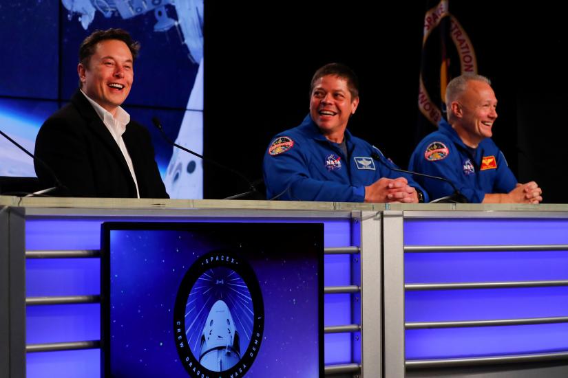 SpaceX founder Elon Musk shares a laugh with NASA Commercial Crew Program astronauts Bob Behnken and Doug Hurley at a post-launch news conference after a SpaceX Falcon 9 rocket, carrying the Crew Dragon spacecraft, lifted off on an uncrewed test flight to the International Space Station from the Kennedy Space Center in Cape Canaveral, Florida, U.S., March 2, 2019. REUTERS
