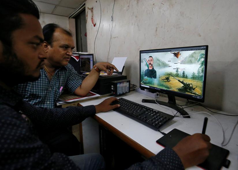A designers works on a graphic image of Indian Air Force pilot Abhinandan Varthaman, who was captured and later released by Pakistan, to be printed on saris, traditional clothing worn by women, inside a sari manufacturing factory in Surat, India, March 8, 2019. REUTERS