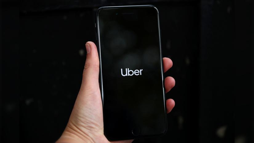 Uber`s logo is displayed on a mobile phone in London, Britain, Sept 14, 2018. REUTERS/File Photo