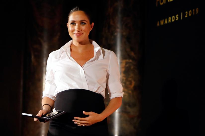 Britain's Meghan, Duchess of Sussex presents the Celebrating Excellence Award to Nathan Forster during the Endeavour Fund Awards in the Drapers' Hall in London, Britain February 7, 2019. REUTERS