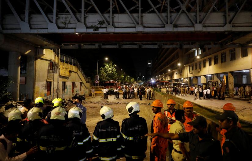 Rescue members stand at the site of a footbridge collapse outside the Chhatrapati Shivaji Terminus railway station in Mumbai, India, March 14, 2019. REUTERS