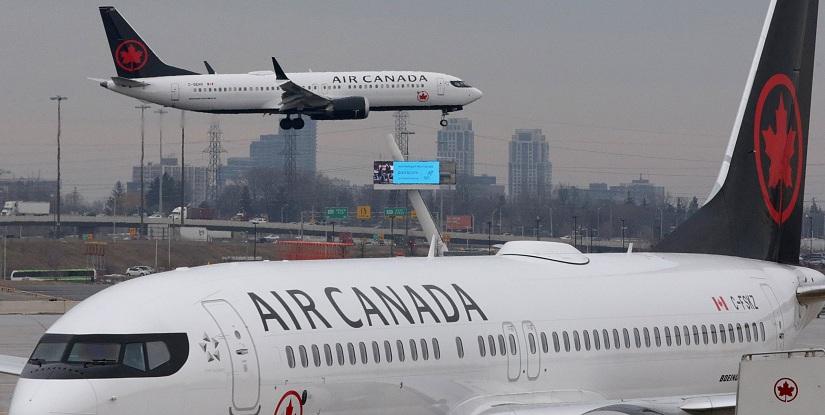 An Air Canada Boeing 737 MAX 8 from San Francisco approaches for landing at Toronto Pearson International Airport over a parked Air Canada Boeing 737 MAX 8 aircraft in Toronto, Ontario, Canada, March 13, 2019. REUTERS