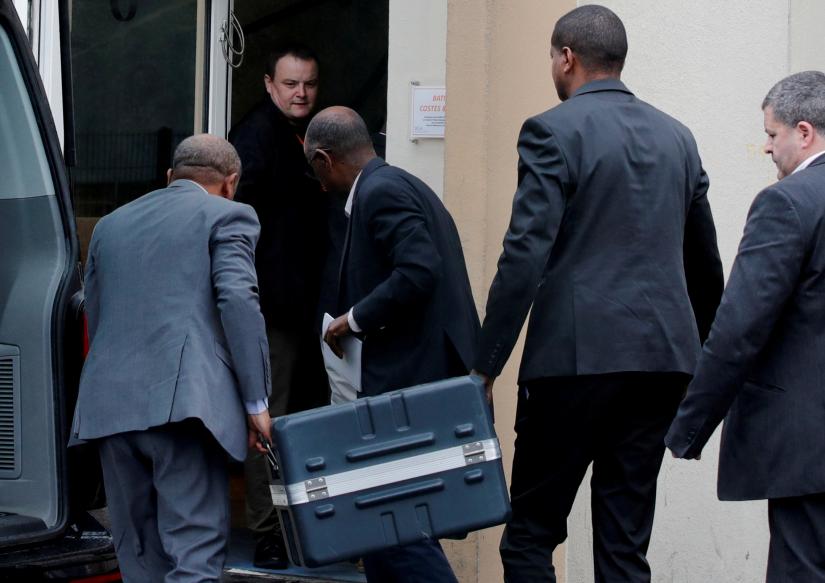 Men unload a case containing the black boxes from the crashed Ethiopian Airlines Boeing 737 MAX 8 outside the headquarters of France`s BEA air accident investigation agency in Le Bourget, north of Paris, France, March 14, 2019. REUTERS/file photo