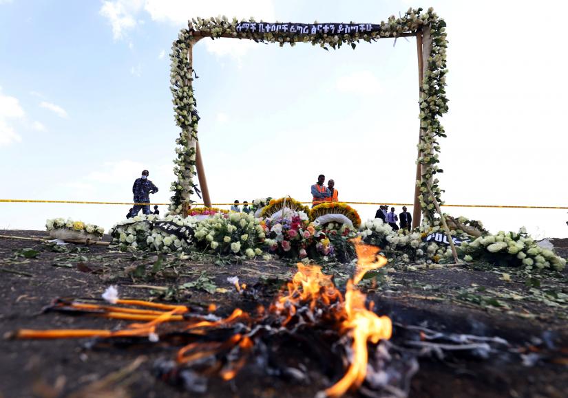 Candle flames burn during a commemoration ceremony for the victims at the scene of the Ethiopian Airlines Flight ET 302 plane crash, near the town Bishoftu, near Addis Ababa, Ethiopia March 14, 2019. REUTERS