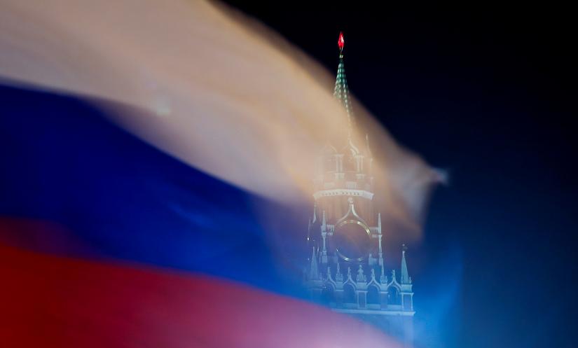 Russian flag flies with the Spasskaya Tower of Moscow`s Kremlin in the background in Moscow, Russia February 27, 2019. REUTERS