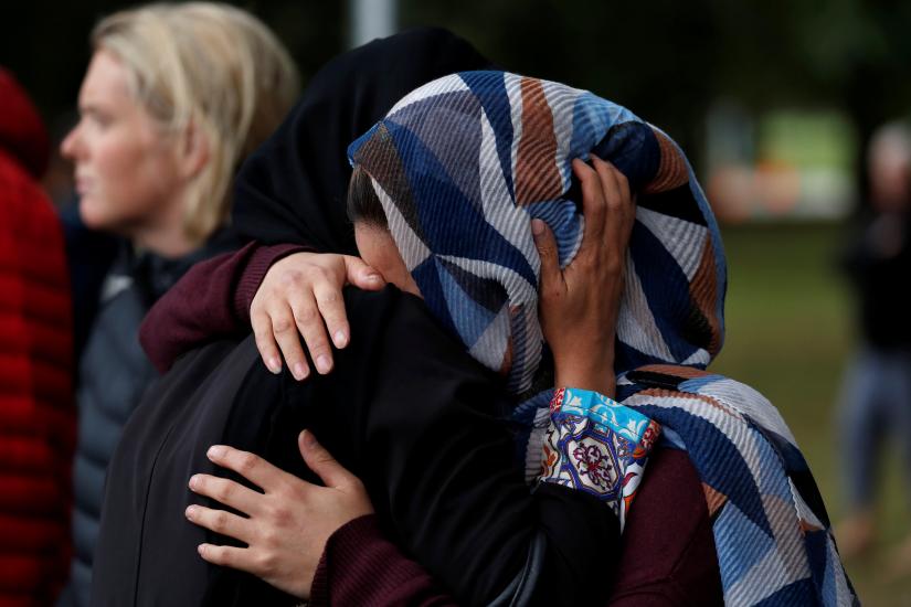 Women embrace near Masjid Al Noor mosque in Christchurch, New Zealand, March 17, 2019. REUTERS