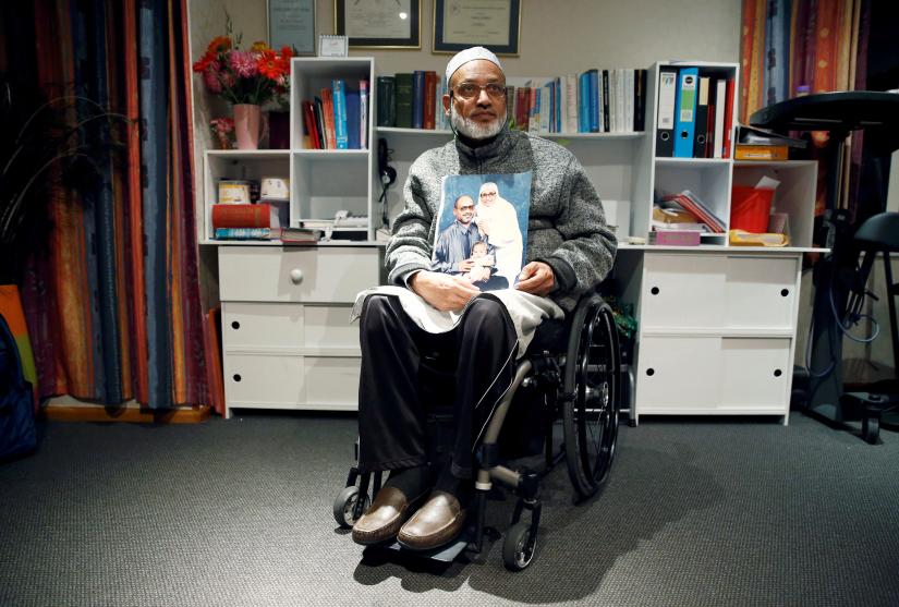 Al Noor mosque shooting survivor Farhid Ahmed poses with a photo of his wife Husna, who was killed in the attack, after an interview with Reuters in Christchurch, New Zealand March 18, 2019. Picture taken March 18, 2019. REUTERS
