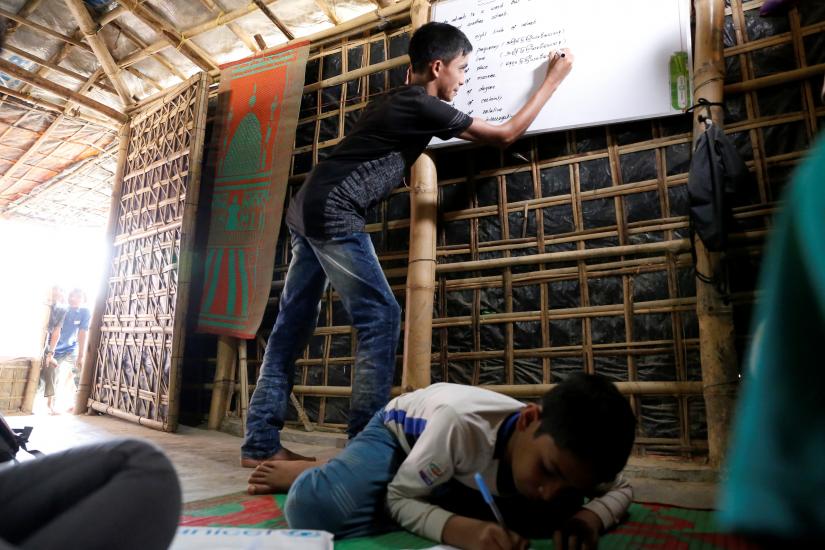 Mohammed Tuahayran, 17, teaches English in a makeshift school at Kutupalong refugee camp in Cox’s Bazar, Bangladesh, February 7, 2019. Picture taken February 7, 2019. REUTERS