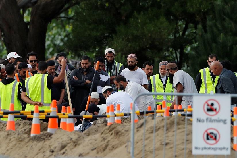 People attend the burial ceremony for the victims of the mosque attacks, at the Memorial Park Cemetery in Christchurch, New Zealand March 20, 2019. REUTERS
