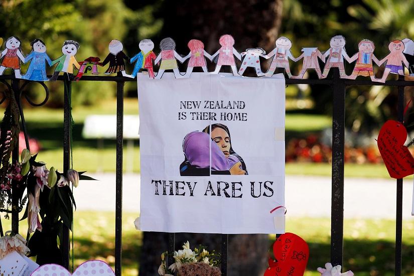 A poster hangs at a memorial site for victims of Friday`s shooting, in front of Christchurch Botanic Gardens in Christchurch, New Zealand March 19, 2019. REUTERS