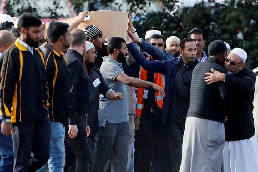 People attend the burial ceremony for the victims of the mosque attacks, at the Memorial Park Cemetery in Christchurch, New Zealand March 20, 2019. REUTERS