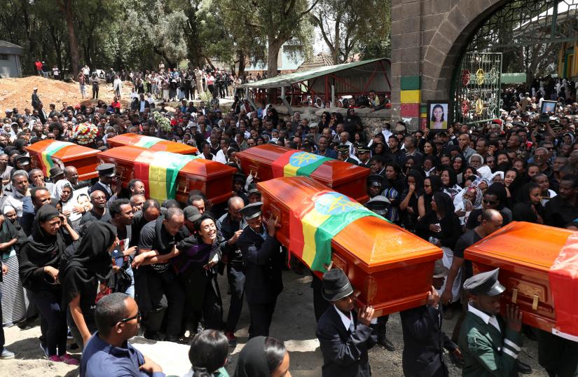 Pallbearers carry the coffins of the victims of the Ethiopian Airline Flight ET 302 plane crash, during the burial ceremony at the Holy Trinity Cathedral Orthodox church in Addis Ababa, Ethiopia, March 17, 2019. REUTERS