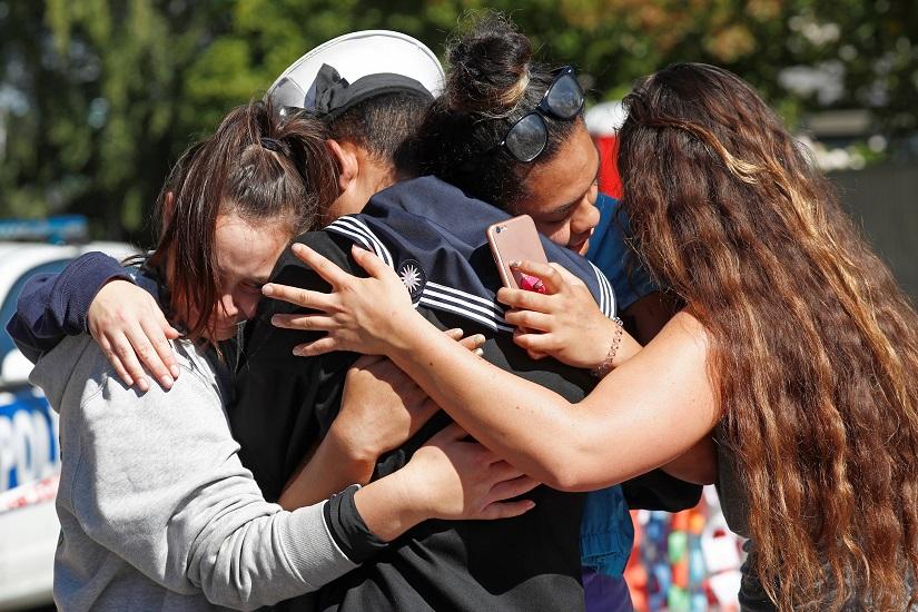 Royal Malaysian Navy (TLDM) Brass Band, Able Rate Abdul Iskandar, who said he was supposed to be at Masjid Al Noor mosque on Friday, the day the shooting, is comforted by bystanders as he weeps at the memorial site for the victims, outside the mosque in Christchurch, New Zealand March 19, 2019. REUTERS