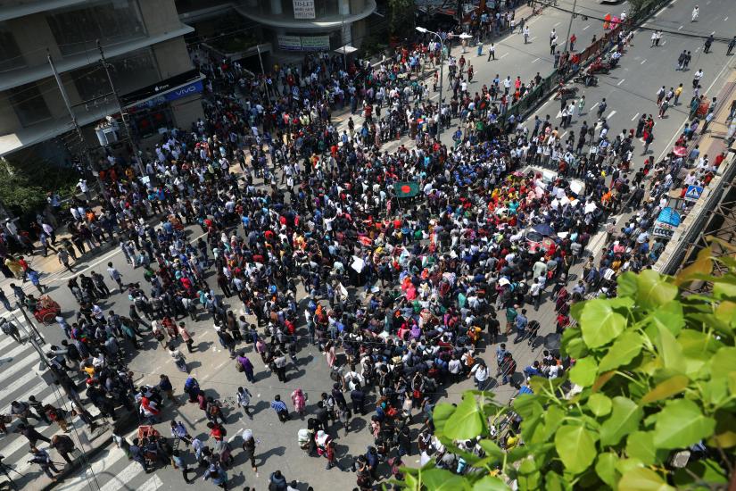Students shout slogans as they block a road to demand road safety after a student died in a road accident in Dhaka, Bangladesh, March 20, 2019. REUTERS