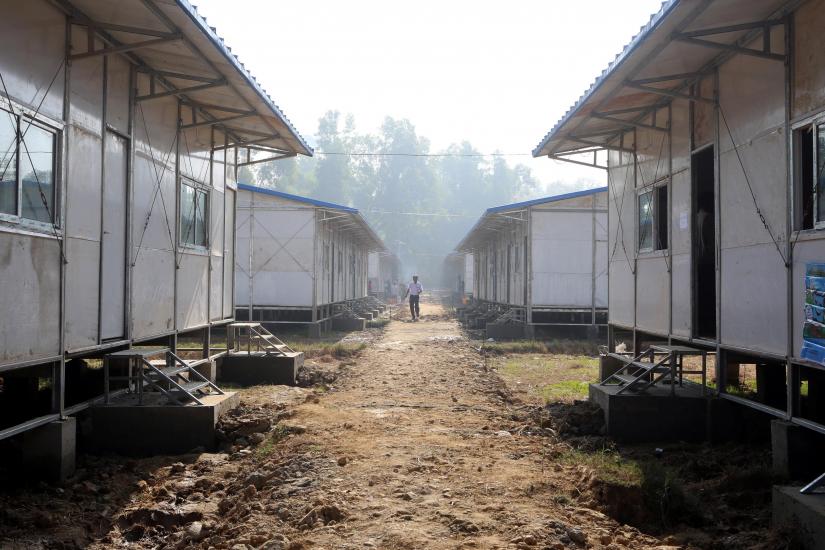 A man walks through the entrance to a camp set up by Myanmar`s Social Welfare, Relief and Resettlement Minister to prepare for the repatriation of displaced Rohingyas. REUTERS