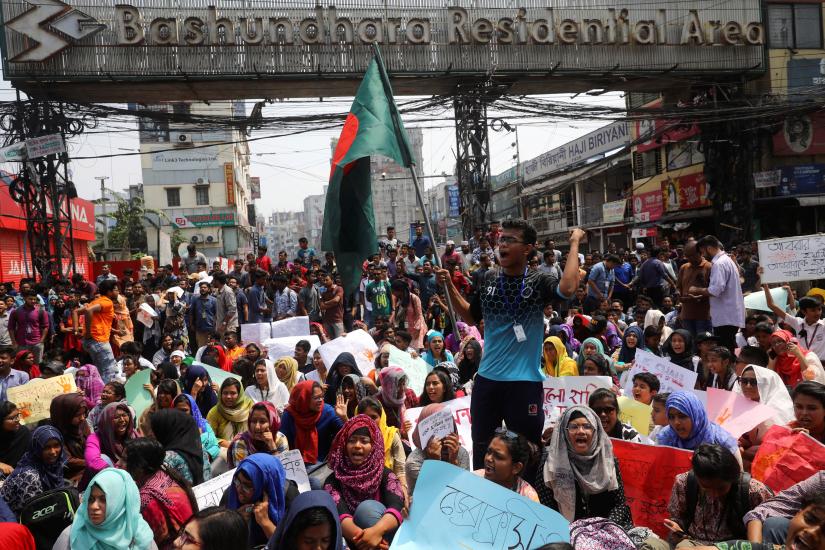 Students shout slogans as they block a road to demand road safety after a student died in a road accident in Dhaka, Bangladesh, March 20, 2019. REUTERS