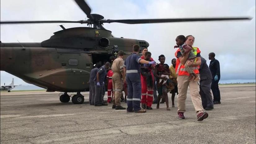 Rescue workers help affected people disembark from a helicopter after cyclone damage in Beira, Mozambique March 19, 2019 in this image taken from social media. Picture taken March 19, 2019. IPSS Medical Rescue via REUTERS