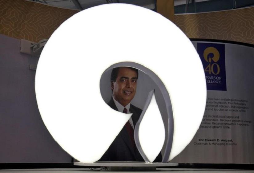 The logo of Reliance Industries is pictured in a stall at the Vibrant Gujarat Global Trade Show at Gandhinagar, India, January 17, 2019. REUTERS/File Photo