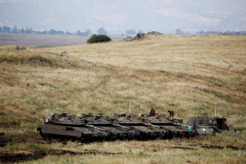 Israeli soldiers stand on tanks near the Israeli side of the border with Syria in the Israeli-occupied Golan Heights, Israel May 9, 2018. REUTERS/File Photo