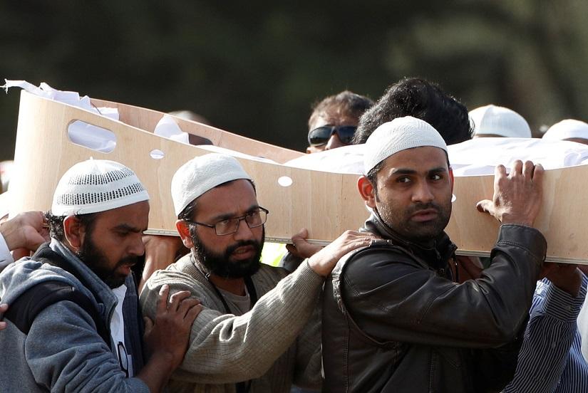 People carry the body of a victim during a burial ceremony for victims of the mosque attacks, at the Memorial Park Cemetery in Christchurch, New Zealand March 22, 2019. REUTERS