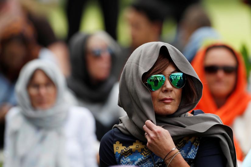 Women wearing headscarves as tribute to the victims of the mosque attacks are seen before Friday prayers at Hagley Park outside Al-Noor mosque in Christchurch, New Zealand March 22, 2019. REUTERS