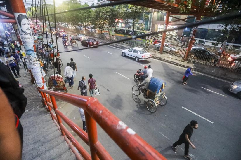 Pedestrians are often seen crossing the road on foot down below. Some were even wearing headphones, while others were carrying children with them. PHOTO/Sazzad Hossain