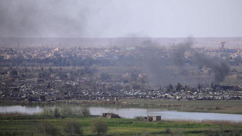 Smoke rises from the last besieged neighborhood in the village of Baghouz, Deir Al Zor province, Syria, March 20, 2019. REUTERS/File Photo
