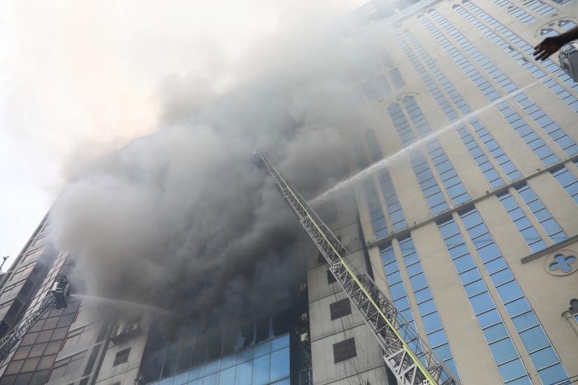 Firefighters attempt to extinguish a fire at a multi-storey commercial building in Dhaka, Bangladesh, March 28, 2019. REUTERS