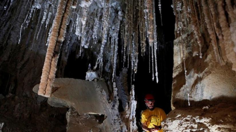 Boaz Langford, a member of Hebrew UniversityÕs Cave Research Center and head of the 2019 Malham Cave Mapping stands next to salt stalactites inside the Malham Cave, which Israeli researchers say is the world`s longest salt cave, in Mount Sodom near the Dead Sea, Israel March 27, 2019. REUTERS