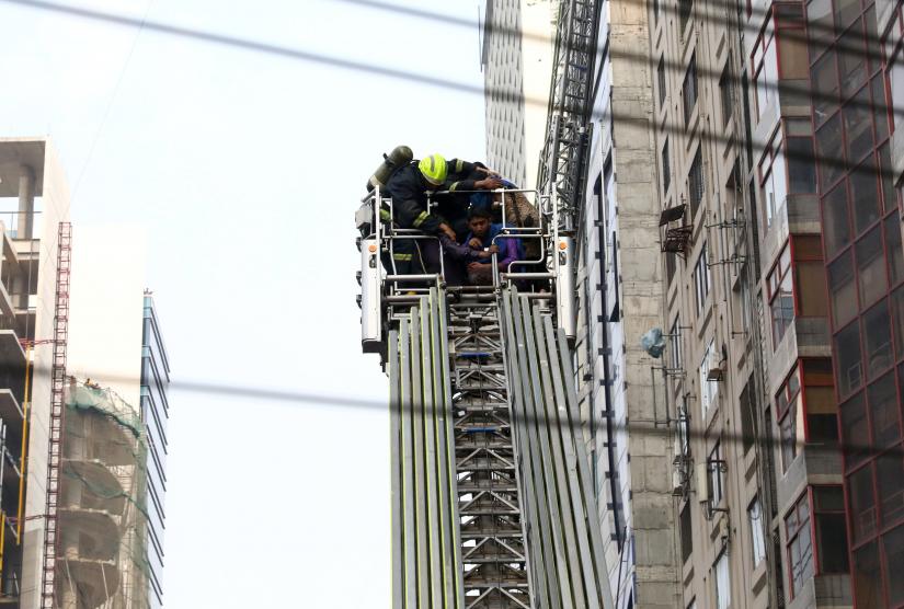 Trapped people are being rescued as fire broke out at a multi-storey commercial building in Dhaka, Bangladesh, March 28, 2019. REUTERS