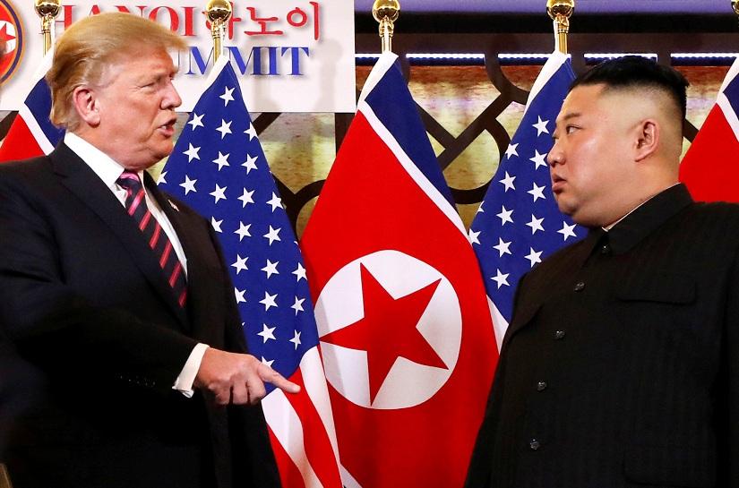 US President Donald Trump speaks to North Korean leader Kim Jong Un after shaking hands before their one-on-one chat during the second U.S.-North Korea summit at the Metropole Hotel in Hanoi, Vietnam Feb 27, 2019. REUTERS/File Photo