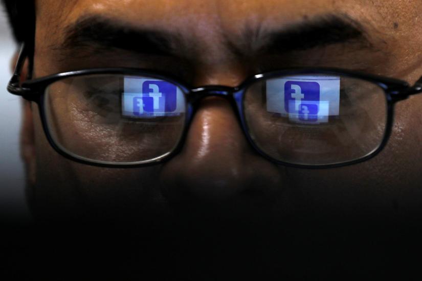 Facebook logo is reflected in glasses in this picture illustration taken April 1, 2019. REUTERS