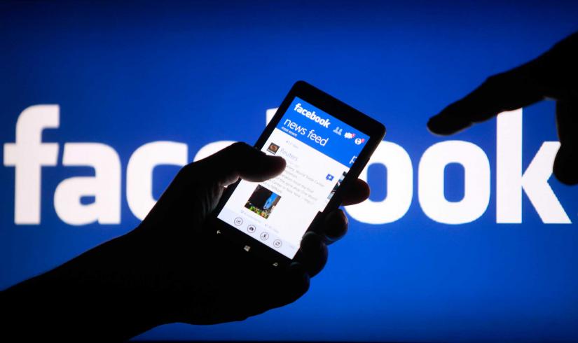 A smartphone user shows the Facebook application on his phone in this photo illustration, May 2, 2013. REUTERS