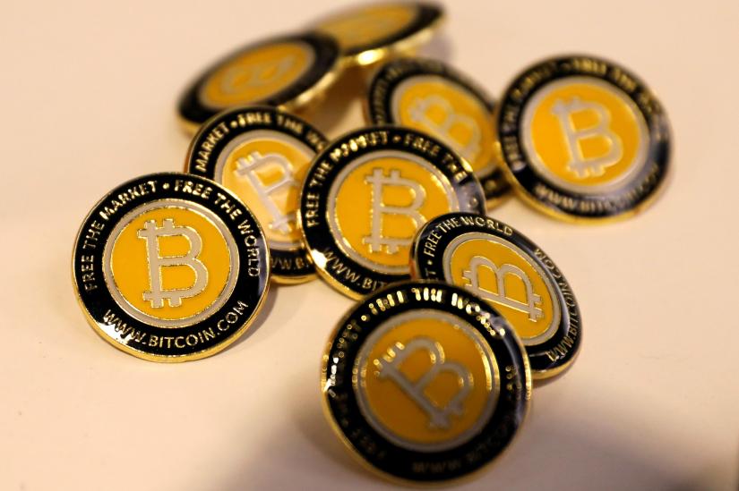 Bitcoin.com buttons are seen displayed on the floor of the Consensus 2018 blockchain technology conference in New York City, New York, U.S., May 16, 2018. REUTERS/File Photo
