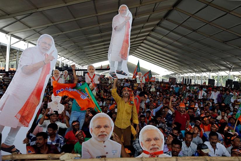 Supporters of India`s ruling Bharatiya Janata Party (BJP) hold cut-outs of Prime Minister Narendra Modi during an election campaign rally addressed by Modi in Kolkata, India, April 3, 2019. REUTERS