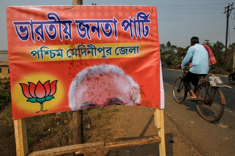 A man rides past the torn poster of Prime Minister Narendra Modi before Bharatiya Janata Party (BJP) rally at Mohanpur village in Paschim Medinipur district, February 6, 2019. REUTERS/File Photo
